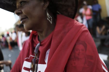 A supporter of Brazil's President Dilma Rousseff wears a shirt with Rousseff's portrait during a rally held by the ruling Workers' Party (PT) for the re-election of Rousseff in Sao Paulo September 6, 2014. REUTERS/Nacho Doce