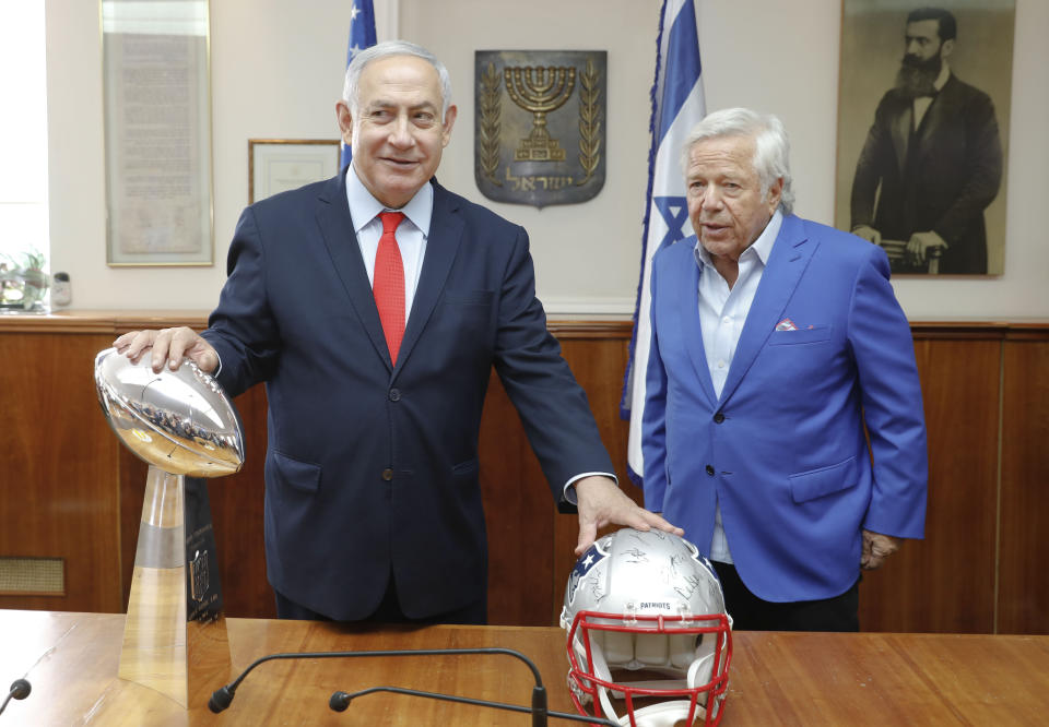 Israel's Prime Minister Benjamin Netanyahu holds the NFL Super Bowl trophy during a meeting with New England Patriots owner Robert Kraft in Jerusalem, Thursday, June 20, 2019. Israel will honor Kraft with the 2019 Genesis Prize for his philanthropy and commitment to combatting anti-Semitism. (AP Photo/Sebastian Scheiner)