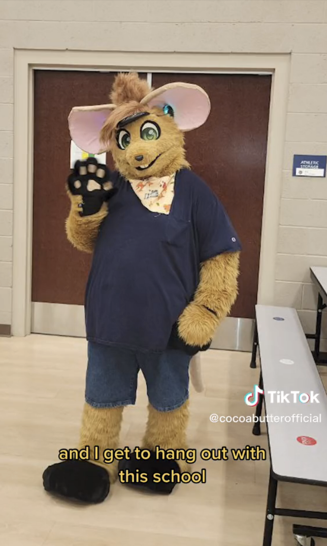 Lamar dressed as Gibson the Mouse at a school