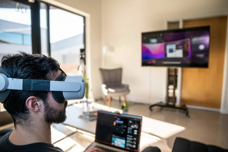 Gavin Menichini gives a demonstration of the Immersed Virtual Reality program at the Immersed offices on January 28, 2022 in Austin, Texas. (Photo by Sergio FLORES / AFP) 