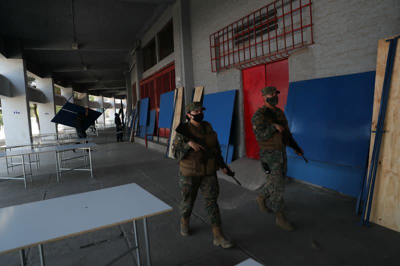 Soldiers patrol inside a polling station ahead of the upcoming referendum on a new Chilean constitution in Santiago