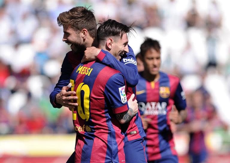 Barcelona's Gerard Pique (L) celebrates with teammate Lionel Messi after scoring during the Spanish league match against Cordoba at El Arcangel stadium in Cordoba on May 2, 2015