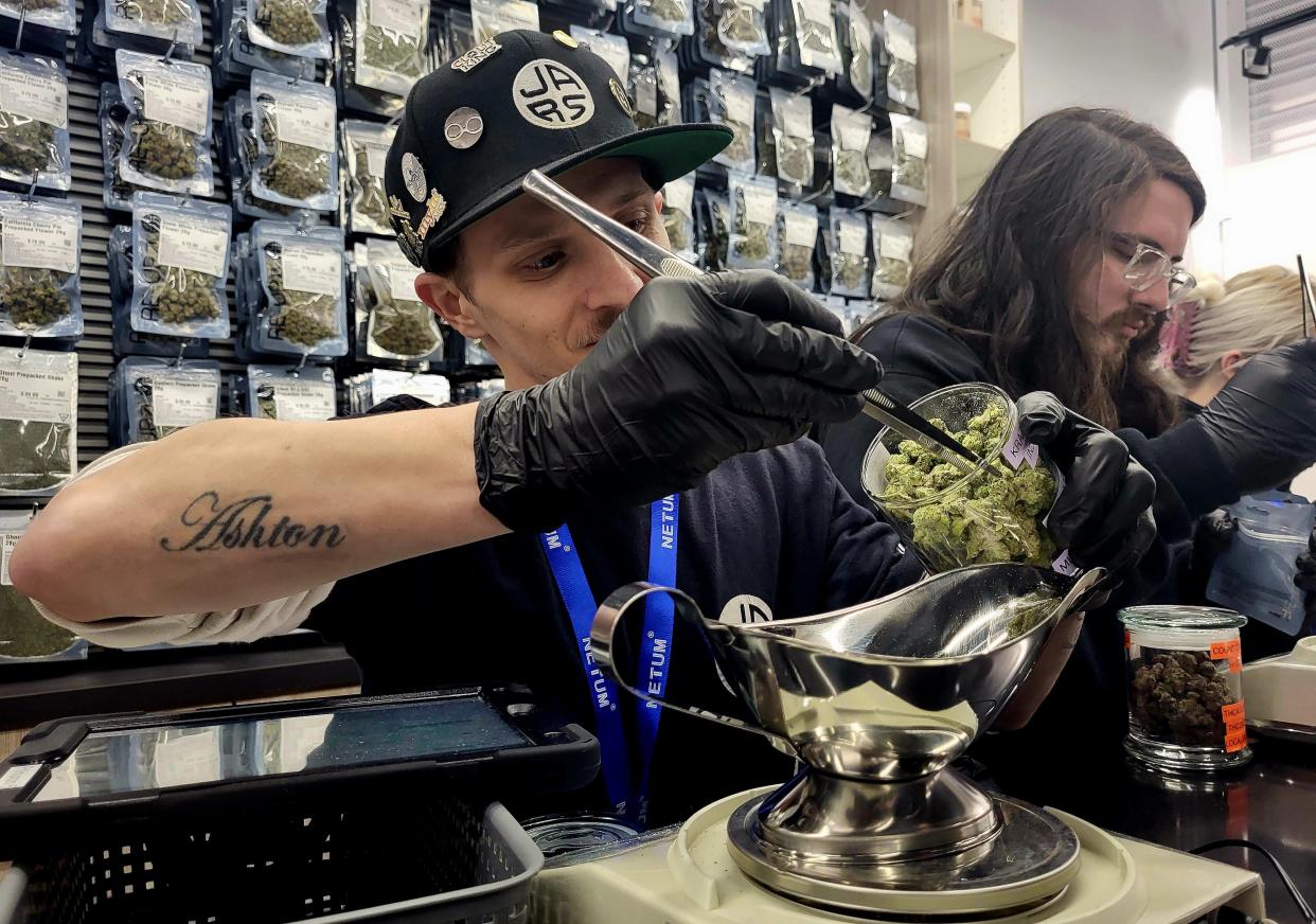 Ryan Keil, a floor leader for the new JARS Cannabis store in downtown Port Huron, measures out some product on Wednesday, Jan. 17, 2024. It was JARS' second day in business, located at Huron Avenue and Quay Street.