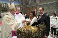 Pope Francis baptises one of 32 babies during a mass in the Sistine Chapel at the Vatican January 12, 2014, in this handout courtesy of Osservatore Romano. REUTERS/Osservatore Romano/Handout via Reuters (VATICAN - Tags: RELIGION) ATTENTION EDITORS - THIS IMAGE WAS PROVIDED BY A THIRD PARTY. FOR EDITORIAL USE ONLY. NOT FOR SALE FOR MARKETING OR ADVERTISING. THIS PICTURE IS DISTRIBUTED EXACTLY AS RECEIVED BY REUTERS, AS A SERVICE TO CLIENTS. NO SALES. NO ARCHIVES