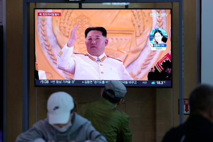 People watch a TV screen showing a news program reporting about North Korea's missile launch with file footage of North Korean leader Kim Jong Un at a train station in Seoul, South Korea, Thursday, May 12, 2022. (Lee Jin- man/AP)