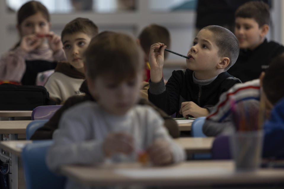 Ukrainian children attend classes at the Polish Center for International Aid Foundation educational facility in Warsaw, Poland, Friday, Feb. 3, 2023. Nearly a year has passed since the Feb. 24, 2022, invasion sent millions of people fleeing across Ukraine's border into neighboring Poland, Slovakia, Hungary, Moldova and Romania. (AP Photo/Michal Dyjuk)