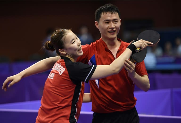 North Korea's Choe Il (R) and his partner South Korea's Yoo Eun-chong (L) celebrate their victory against Spain