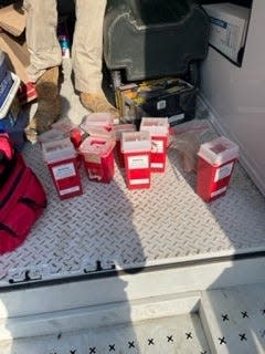 Workers reported finding thousands of used hypodermic needles on the ground at a homeless encampment behind Bloomington's At Home store. They were collected and put into these safety containers.