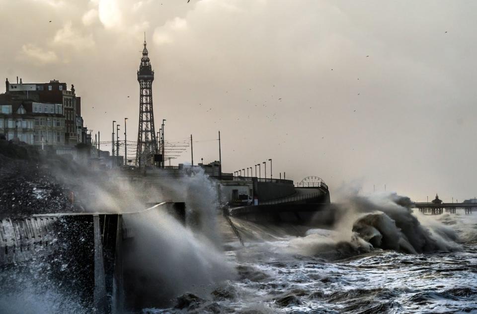 Waves break on the sea front in Blackpool. (PA)