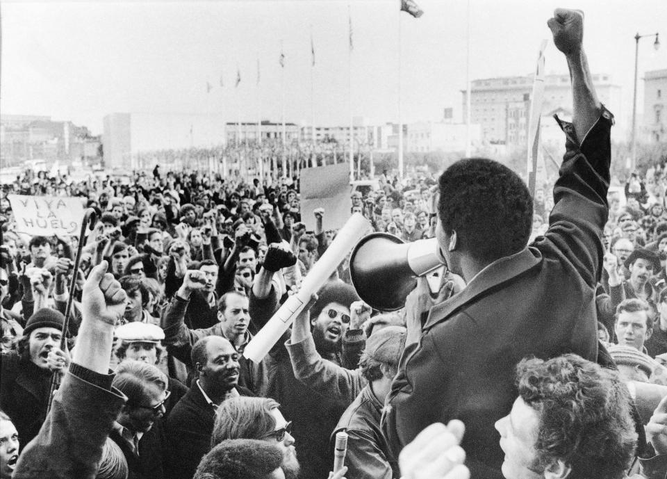 A Black Students Union leader in front of a crowd of demonstrators at San Francisco State College in December 1968. The union had gone on strike after racial strife between students and administration. Below, rebellious students occupied part of Howard University Washington, in March 1968, to demand more black-oriented courses.