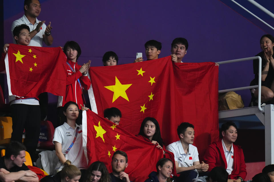 Fans of China celerate after Chang Yani and Chen Yiwen of China won gold and silver during the women's 3m springboard diving final at the World Aquatics Championships in Doha, Qatar, Friday, Feb. 9, 2024. (AP Photo/Hassan Ammar)