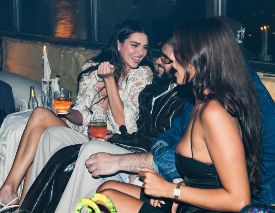 Split sweethearts Kendall Jenner, 28, and Bad Bunny, 30, shared a sweet laugh while snuggling up at WSA downtown, where Emily Ratajkowski co-hosted a party. WWD via Getty Images