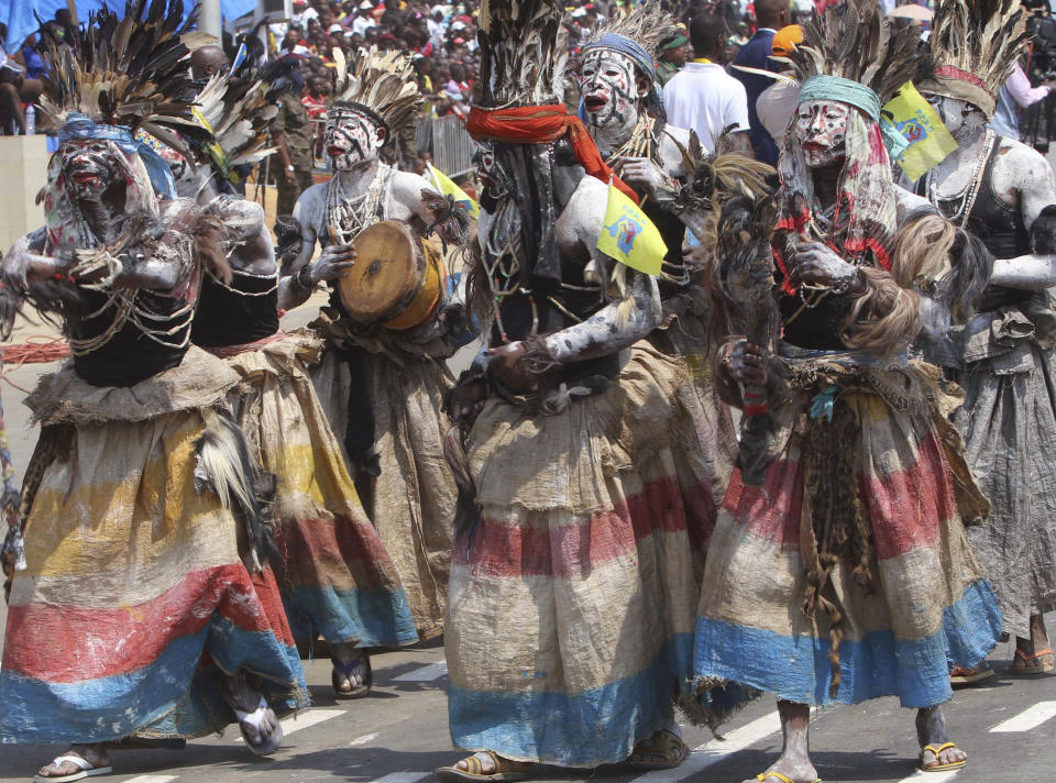 FILE - In this June 30 2016 file photo shot by AP contributing photographer John Bompengo, performers in traditional clothing celebrate the 56th anniversary of the Democratic Republic of Congo's independence from Belgium, in Kindu, Democratic Republic of Congo. Relatives say longtime Associated Press contributor John Bompengo has died of COVID-19 in Congo's capital. Bompengo, who had covered his country's political turmoil over the course of 16 years, died Saturday, June 20, 2020 at a Kinshasa hospital. (AP Photo/John Bompengo, file)