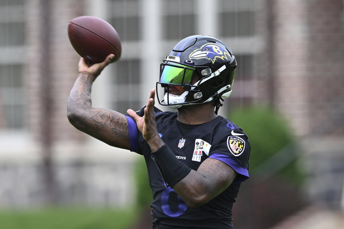 Baltimore Ravens quarterback Lamar Jackson (8) takes to the field with a  member of the military as part of Salute to Service before an NFL football  game against the Carolina Panthers, Sunday