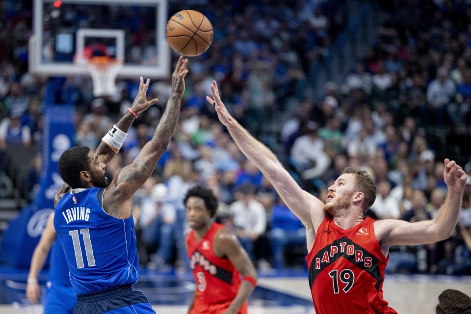 Dallas Mavericks guard Kyrie Irving (11) shoots over Toronto Raptors center Jakob Poeltl (19) during the first half of an NBA basketball game, Wednesday, Nov. 8, 2023, in Dallas. (AP Photo/Gareth Patterson)