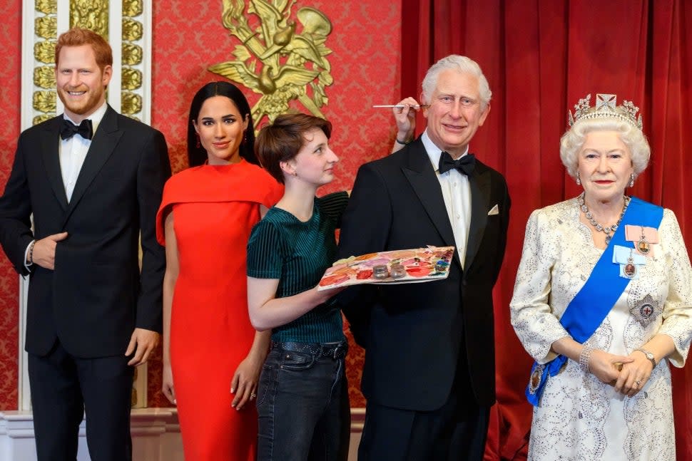 Figures of Meghan and Harry with Charles and the queen at Madame Tossauds London