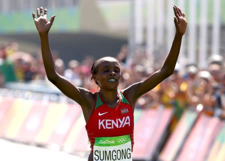 2016 Rio Olympics - Athletics - Final - Women's Marathon -Sambodromo - Rio de Janeiro, Brazil - 14/08/2016. Jemima Sumgong (KEN) of Kenya crosses the finish line to win the race REUTERS/David Gray