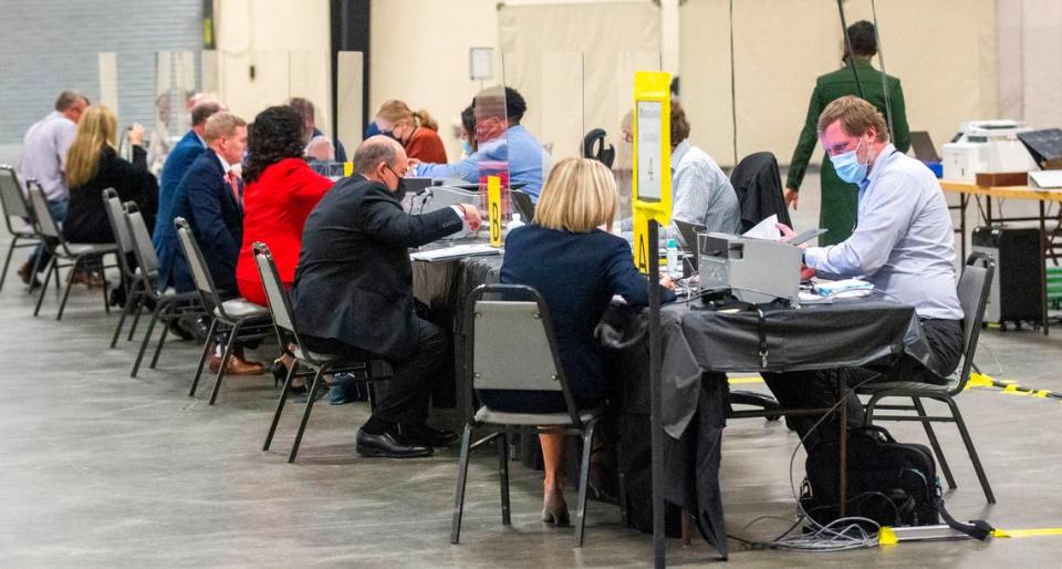 State Board of Elections workers help candidates file for federal, state and local races at the NC State Fairgrounds Monday, Dec. 6, 2021. A court order Monday temporarily blocked U.S. House, state Senate and state House seat candidates from filing to run in the 2022 elections under the districts drawn by Republican state lawmakers.