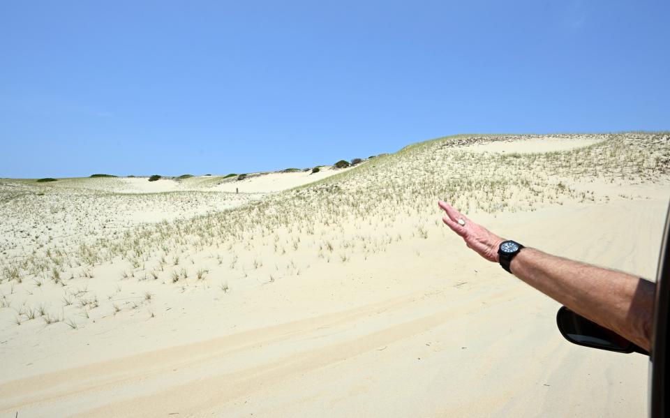 Peter Clemons points to sites along the trail to his family's dune shack in Provincetown.