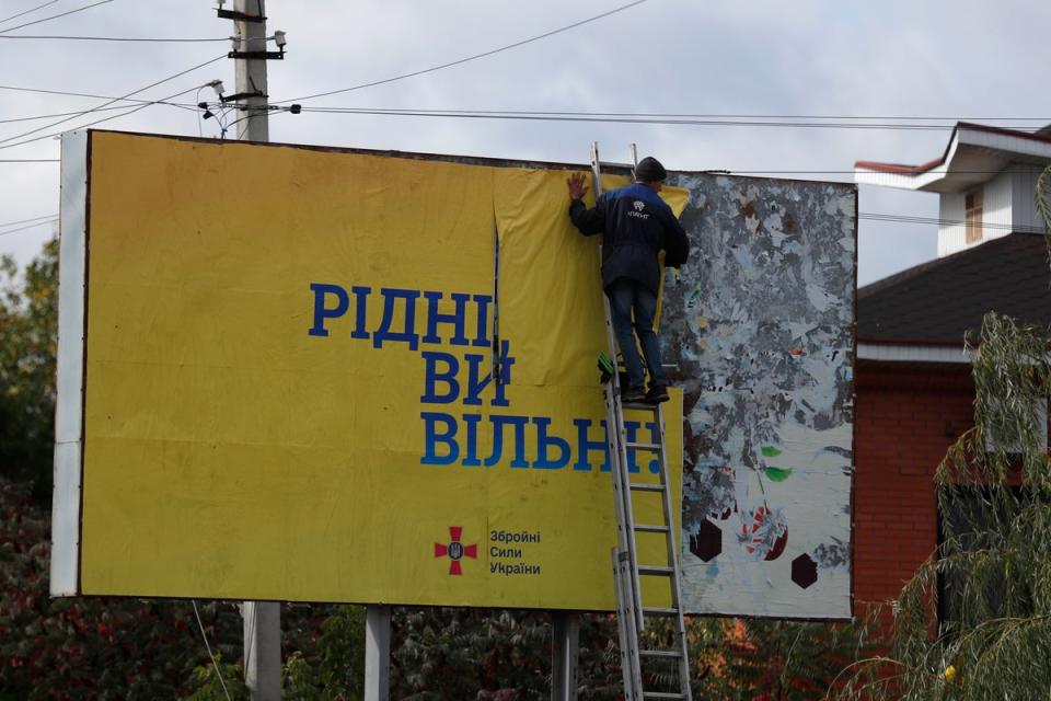 ‘Citizens you are free’: A billboard in the newly liberated city of Kupiansk, east of Kharkiv, on Monday (EPA)