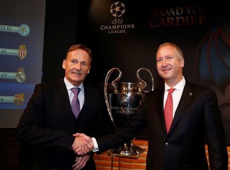 Borussia Dortmund CEO Hans-Joachim Watzke (L) shakes hands with AS Monaco Vice President Vadim Vasilyev after the draw of the UEFA Champions League quarterfinals in Nyon, Switzerland March 17, 2017. REUTERS/Denis Balibouse