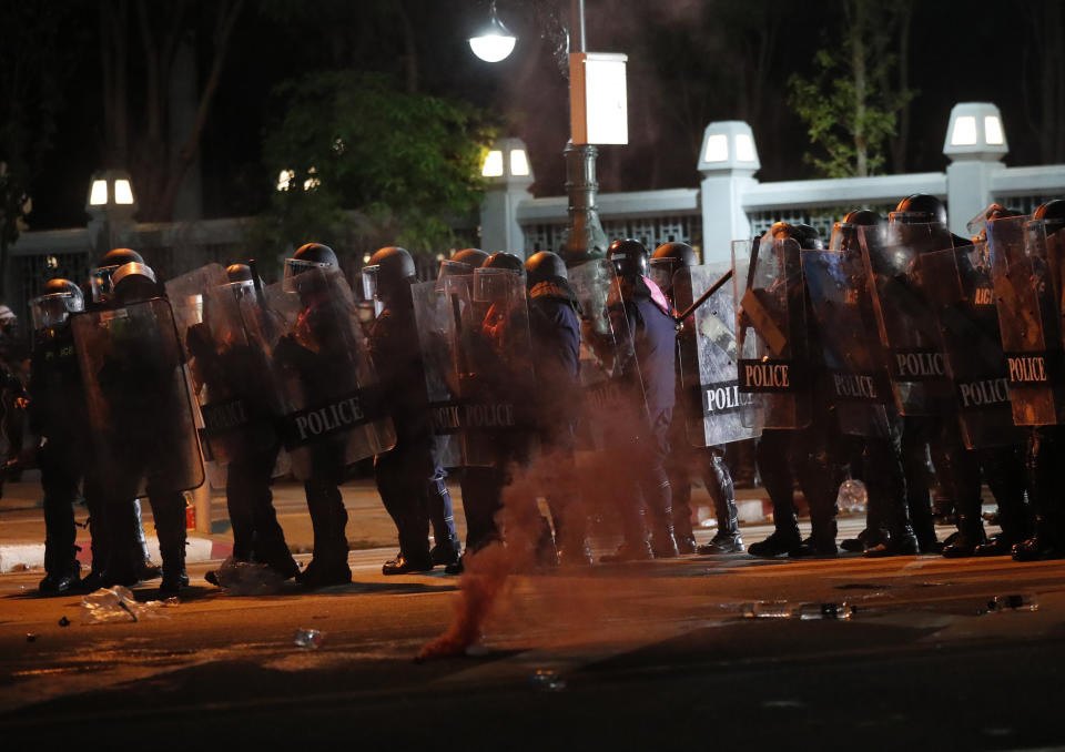 Riot police stand together during dispersal of protesters who removed container vans used as a barricade in front of the Grand Palace Saturday, March 20, 2021 in Bangkok, Thailand. Thailand's student-led pro-democracy movement is holding a rally in the Thai capital, seeking to press demands that include freedom for their leaders, who are being held without bail on charges of defaming the monarchy. (AP Photo/Sakchai Lalit)