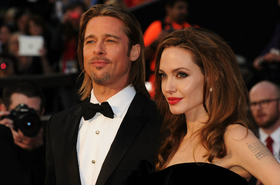 Brad Pitt and Angelina Jolie pose for the camera.