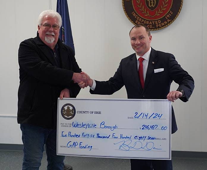 Wesleyville Borough Mayor E. Paul Johnson, on left, receives a GAP fund check from Erie County Executive Brenton Davis.