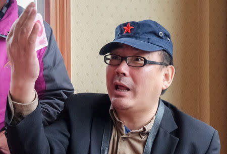 Yang Hengjun, author and former Chinese diplomat, who is now an Australian citizen, gestures in an unspecified location in Tibet, China, sometime in mid-July, 2014 in this social media image obtained by REUTERS/Files