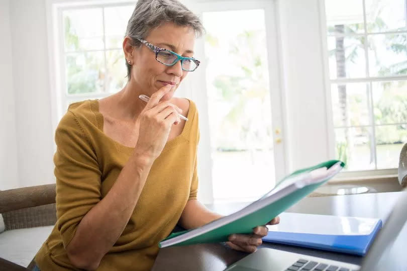 A woman looking at financial paperwork