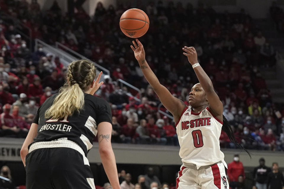 North Carolina State guard Diamond Johnson (0) shoots while Louisville forward Emily Engstler (21) looks on during the second half of an NCAA college basketball game in Raleigh, N.C., Thursday, Jan. 20, 2022. (AP Photo/Gerry Broome)