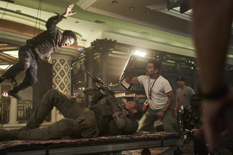 Dave Bautista shoots a zombie in Zack Snyder's Army of the Dead for Netflix.