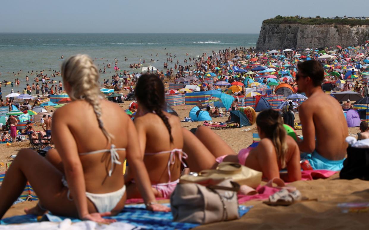 Beach-goers sunbathe in a hot summer day at the coast - REUTERS/Lisi Niesner