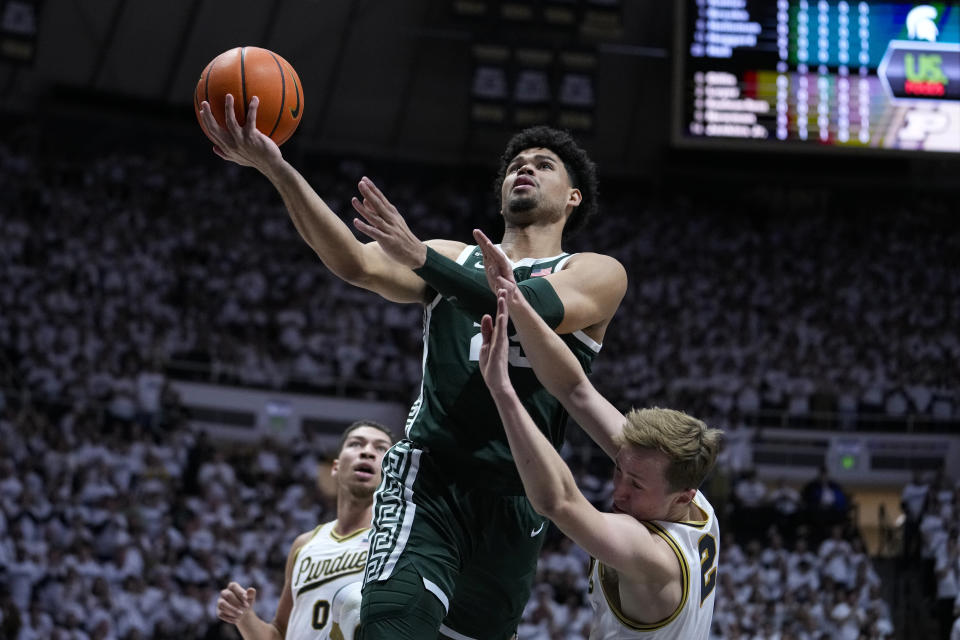 Purdue guard Fletcher Loyer (2) draws the offensive foul from Michigan State forward Malik Hall (25) during the first half of an NCAA college basketball game in West Lafayette, Ind., Sunday, Jan. 29, 2023. (AP Photo/Michael Conroy)