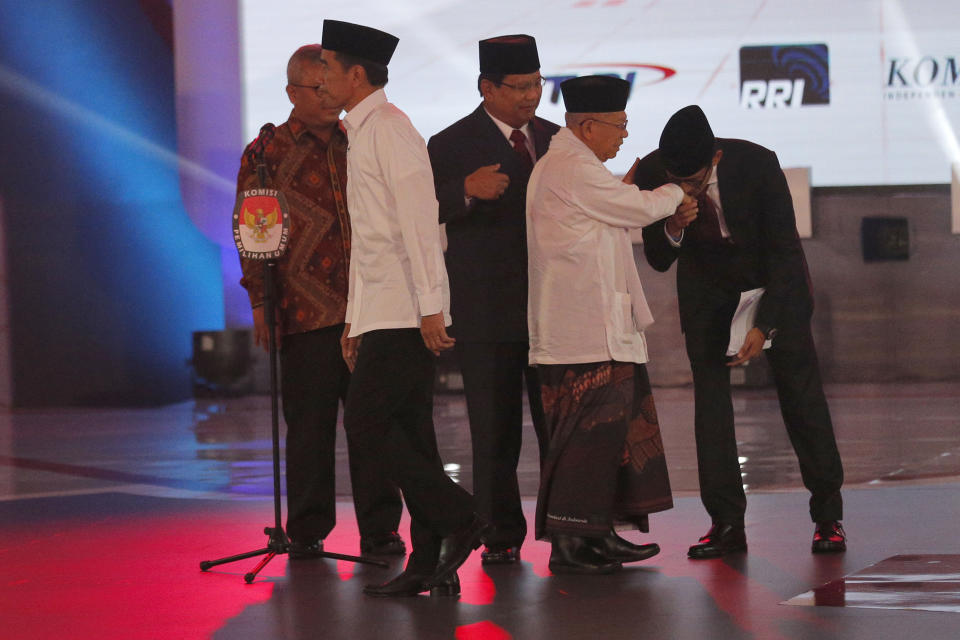 Indonesian President Joko Widodo, left, and his running mate Ma'ruf Amin, second right, and his contender Prabowo Subianto, center, with his running mate Sandiaga Uno, right, shake hands during a televised debate in Jakarta, Indonesia, Thursday, Jan. 17, 2019. Indonesia is gearing up to hold its presidential election on April 17 that will pit in the incumbent against the former general.(AP Photo / Tatan Syuflana)