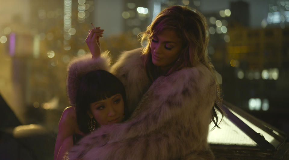 This image released by STXfilms shows Constance Wu, left, and Jennifer Lopez in a scene from "Hustlers." The film will premiere at the Toronto International Film Festival in September. (STXfilms via AP)