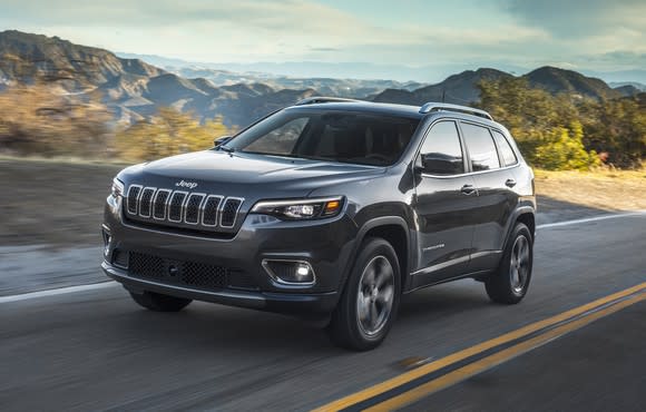 A 2019 Jeep Cherokee, a midsize crossover SUV, on a country road.