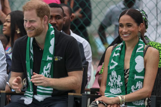 <p>KOLA SULAIMON/AFP via Getty</p> Prince Harry and Meghan Markle attend an exhibition sitting volleyball match at Nigeria Unconquered, a local charity organisation that supports wounded, injured, or sick servicemembers, in Abuja on May 11, 2024