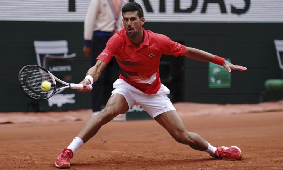 Novak Djokovic executes a perfect slide to return a forehand