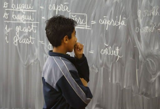 Lulu looks at a blackboard at a school in Bucharest's Ferentari district in 2003. One in two Romanian high school pupils failed their university exemption exams this year, a record low level after new anti-fraud measures cut back on cheating, new figures showed