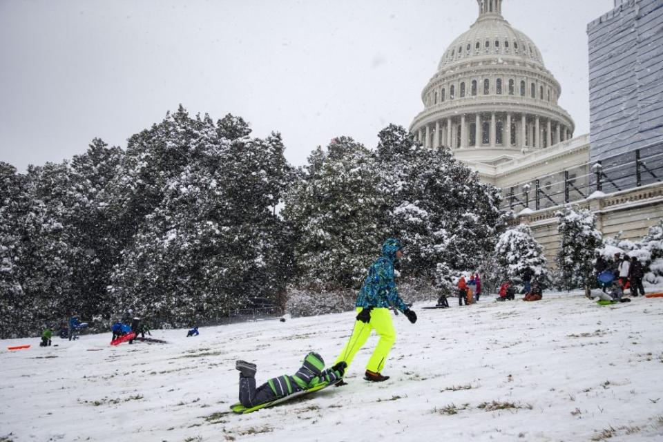 A man pulls his son up the hill as people sled on the west side of the U.S. Capitol, on January 13, 2019 in Washington, DC. The DC area was hit with 4-7 inches of snow accumulation with the potential of another 2-4 inches. President Donald Trump is holding off from a threatened national emergency declaration to fund a border wall amidst the longest partial government shutdown in the nation’s history. (Photo by Al Drago/Getty Images)