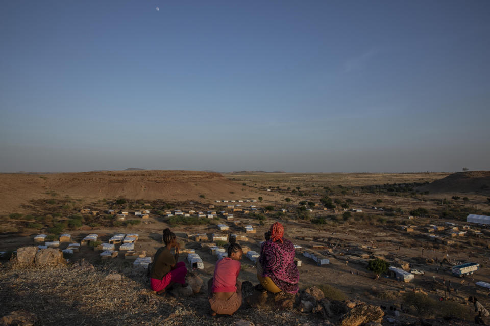 Tigray women who fled the conflict in Ethiopia's Tigray region, sit on a hill top overlooking Umm Rakouba refugee camp, in Qadarif, eastern Sudan, Thursday, Nov. 26, 2020. Ethiopia's prime minister said Thursday the army has been ordered to move on the embattled Tigray regional capital after his 72-hour ultimatum ended for Tigray leaders to surrender, and he warned the city's half-million residents to stay indoors and disarm. (AP Photo/Nariman El-Mofty)