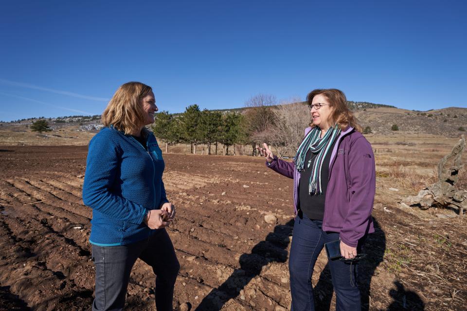 Meegan Flenniken (left), from the Larimer County Department of Natural Resources, and county commissioner Jody Shadduck-McNally (right) walk on the 1,547-acre Blue Mountain property on Thursday, March 21, 2024.