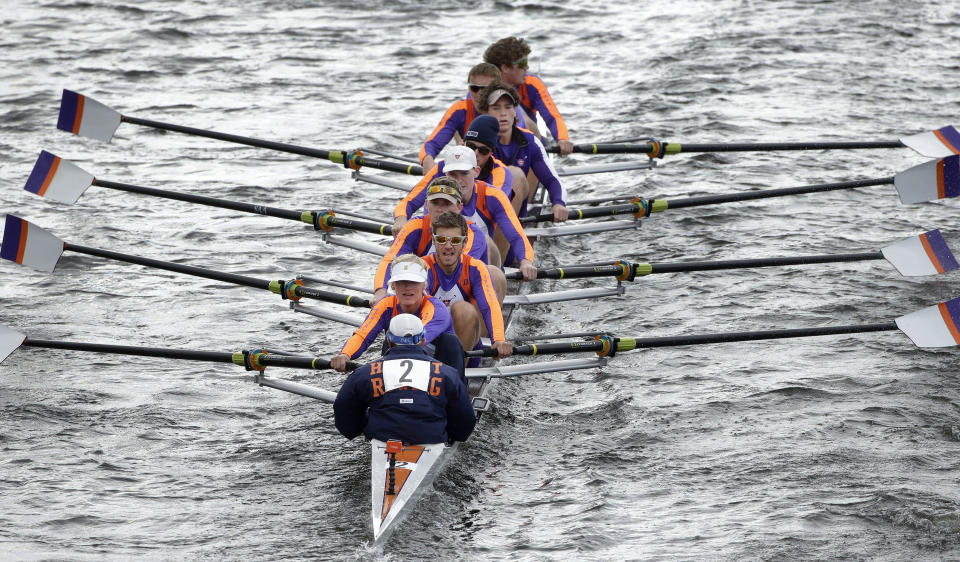 FILE - Hobart College's crew team row in the men's collegiate eights during the Head of the Charles Regatta on the Charles River in Cambridge, Mass., Sunday, Oct. 18, 2015. While the Michigans, UCLAs and Dukes of the world are banking on millions and billions coming out of the massive changes in college sports, nobody needs this to work more than the college rowers, wrestlers and gymnasts around the nation. (AP Photo/Steven Senne, File)