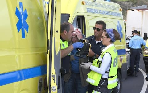 A man receives medical assistance after the crash  - Credit: AFP