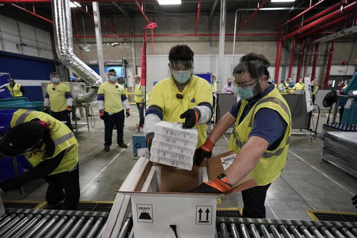 <span class="caption">Workers prepare to ship the Pfizer COVID-19 vaccine from the company's manufacturing plant in Kalamazoo, Michigan.</span> <span class="attribution"><a class="link " href="https://www.gettyimages.com/detail/news-photo/boxes-containing-the-pfizer-biontech-covid-19-vaccine-are-news-photo/1230101627?adppopup=true" rel="nofollow noopener" target="_blank" data-ylk="slk:Morry Gash/Pool/AFP via Getty Images;elm:context_link;itc:0;sec:content-canvas">Morry Gash/Pool/AFP via Getty Images</a></span>