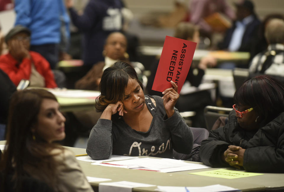 Vonettia Midgett, of Detroit, awaits assistance as the massive recounting of ballots begins for Wayne County's portion of the presidential election in Detroit on Dec. 6, 2016. (Max Ortiz / Detroit News via AP file)