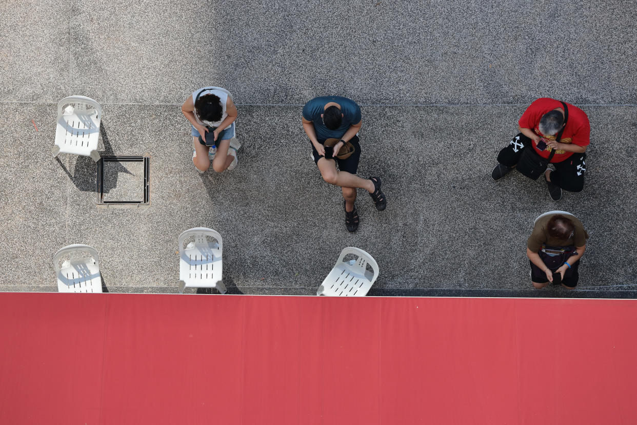 People wait outside a clinic to receive the the China made COVID-19 Sinovac vaccine on June 24, 2021 in Singapore. Singapore allowed the usage of the Sinovac vaccine under the Special Access Route (SAR) framework even though the vaccine remains unregistered and is not authorised by the Health Sciences Authority (HSA). Under the SAR, COVID-19 vaccines approved by the World Health Organisation (WHO) for Emergency Use List (EUL) can be imported and supplied by private healthcare institutions. This will allow individuals an alternative to choose other than the city state approved vaccine, such as Pfzer-BioNTech and Moderna. (Photo by Suhaimi Abdullah/NurPhoto via Getty Images)