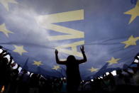 Protesters wave and dance under a huge EU flag during a pro-Euro rally in front of the parliament building, in Athens, Greece, June 30, 2015. REUTERS/Yannis Behrakis