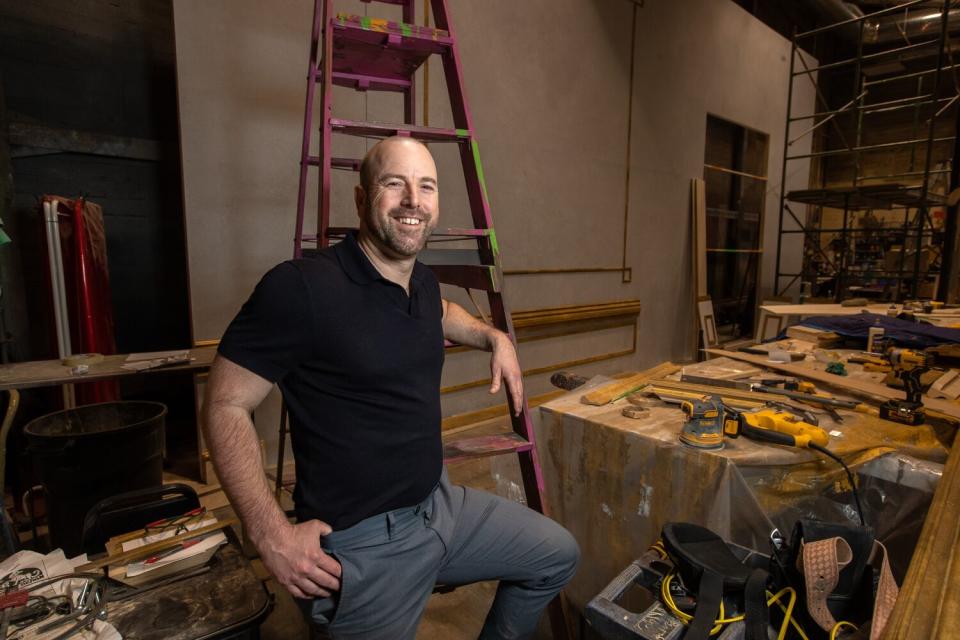 Danny Feldman stands in front of a ladder backstage at the Pasadena Playhouse.